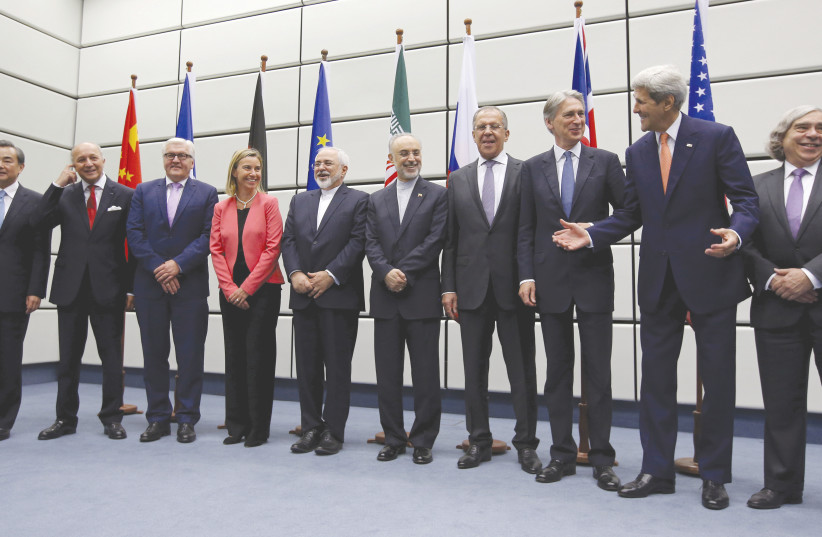OFFICIALS FROM Iran and the six major world powers pose for a group picture after reaching the JCPOA in Vienna in 2015. (photo credit: REUTERS/CARLOS BARRIA)