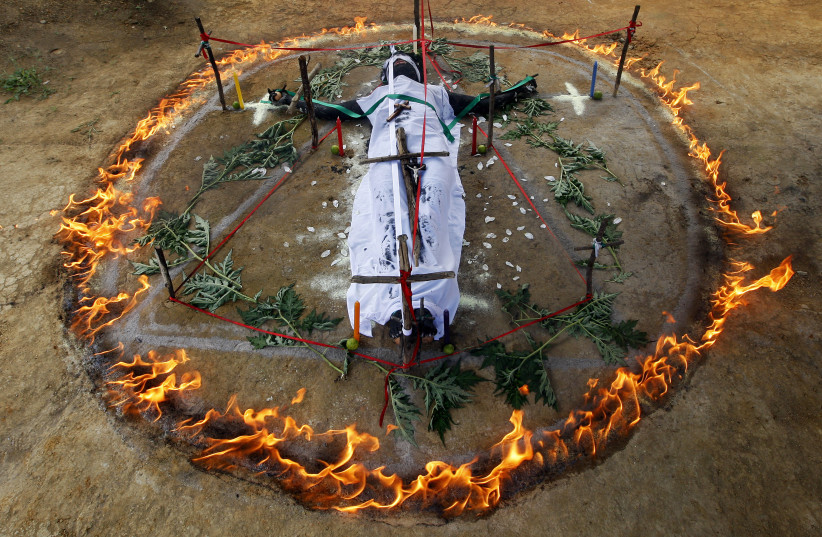  Gisela Marulanda, 23, who claims to be possessed by spirits, participates in an exorcism ritual performed by Hermes Cifuentes (not pictured) in La Cumbre, Valle September 5, 2012. (photo credit: Jaime Saldarriaga/Reuters)