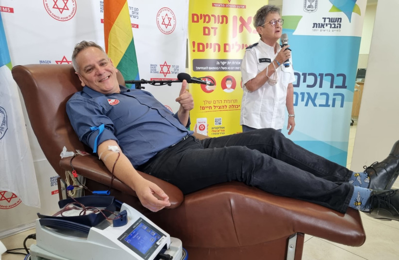 Israel's Health Minister Nitzan Horowitz is seen giving blood at the Magen David Adom compound in Jerusalem, on October 25, 2021. (credit: Moshe Hermon/GPO)