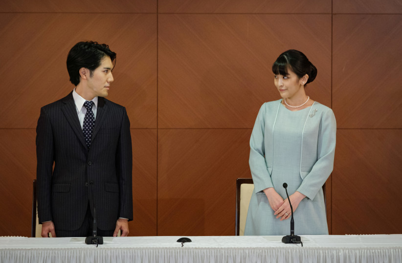 Former Japanese princess Mako, a niece of Emperor Naruhito, and her husband Kei Komuro front the press at a Tokyo hotel on Oct. 26, 2021, following their marriage earlier in the day. She became Mako Komuro under a family registry with Komuro. (photo credit: THE YOMIURI SHIMBUN)