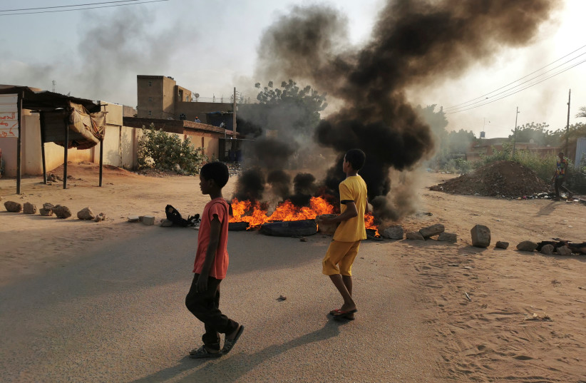  A road barricade is set on fire during what the information ministry calls a military coup in Khartoum, Sudan, October 25, 2021 (photo credit: REUTERS/EL TAYEB SIDDIG)