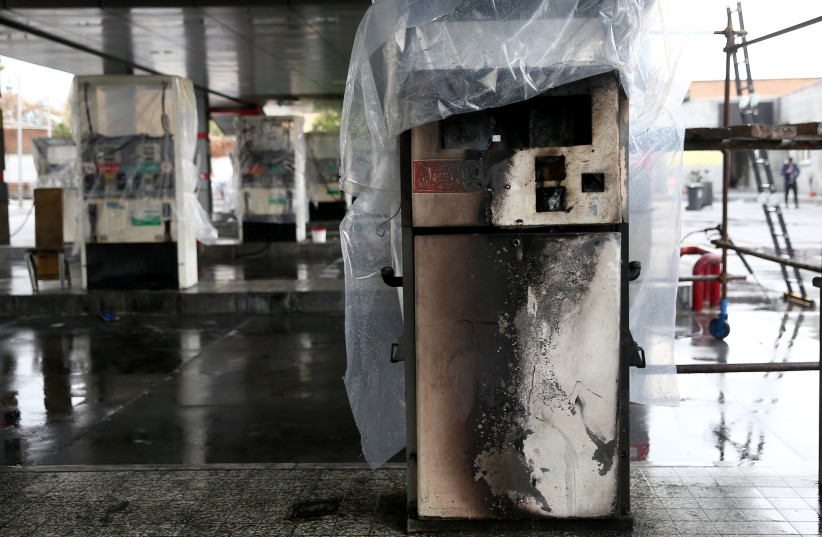 Destroyed petrol pumps are pictured at a gas station, after protests against increased fuel prices, in Tehran. (credit: REUTERS)