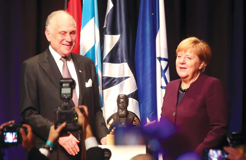 World Jewish Congress President Ronald S. Lauder presents the Theodor Herzl Award to German Chancellor Angela Merkel in Munich on October 28, 2019.  (credit: MICHAEL DALDER/REUTERS)