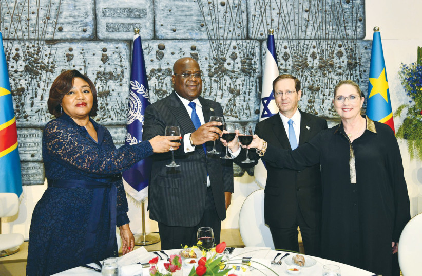 PRESIDENT ISAAC HERZOG, DRC President Felix Tshusikedi and their wives, Michal and Denise, raise a toast at a state dinner Herzog hosted for the visiting president. (photo credit: HAIM ZACH/GPO)