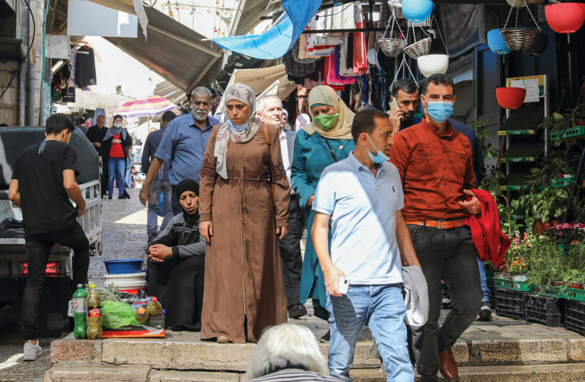 PEOPLE WALK in the Muslim Quarter of Jerusalem’s Old City yesterday. Are Israel’s moves supressing Palestinian civil society? (credit: MARC ISRAEL SELLEM/THE JERUSALEM POST)