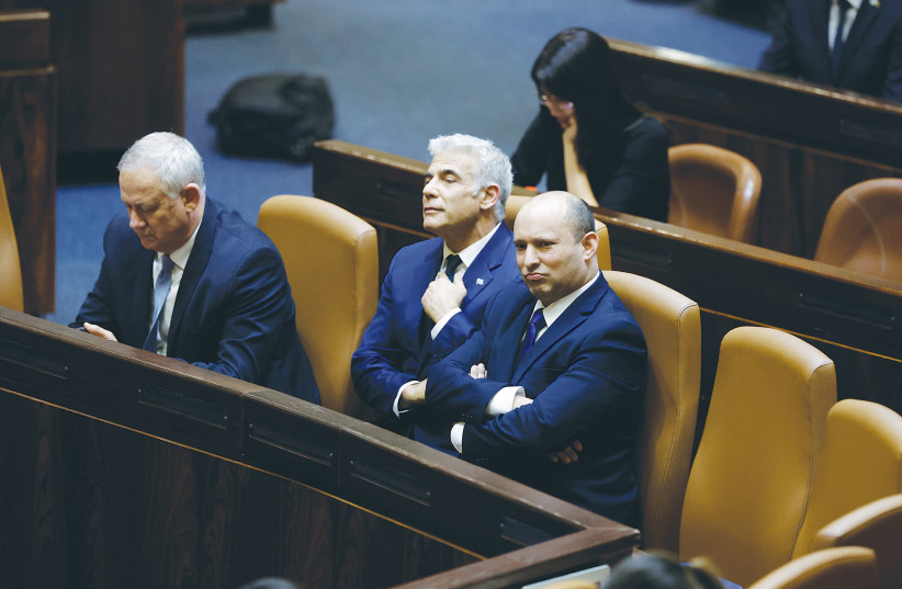  PRIME MINISTER Naftali Bennett and Foreign Minister Yair Lapid at the Knesset session in which their government was inaugurated in June. (photo credit: OLIVIER FITOUSSI/FLASH90)