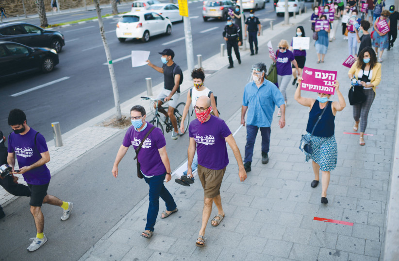  DEMONSTRATORS AT Tel Aviv’s Azrieli junction protest during the first months of the pandemic last year calling for greater governmental financial aid.  (photo credit: TOMER NEUBERG/FLASH90)