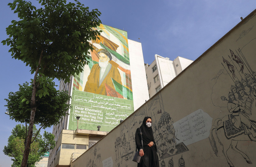  A MURAL depicting Iran’s late leader Ayatollah Ruhollah Khomeini looms over a Tehran street.  (photo credit: MAJID ASGARIPOUR/WANA (WEST ASIA NEWS AGENCY) VIA REUTERS)