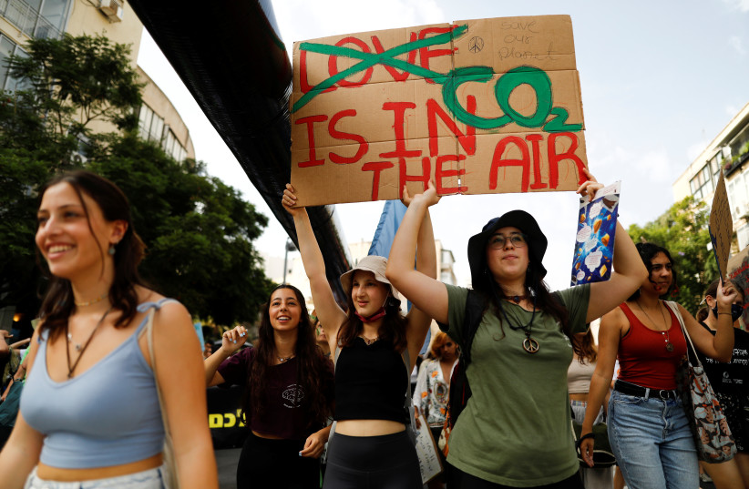  People take part in a protest against climate change in Tel Aviv, Israel October 29, 2021.  (credit: REUTERS/CORINNA KERN)