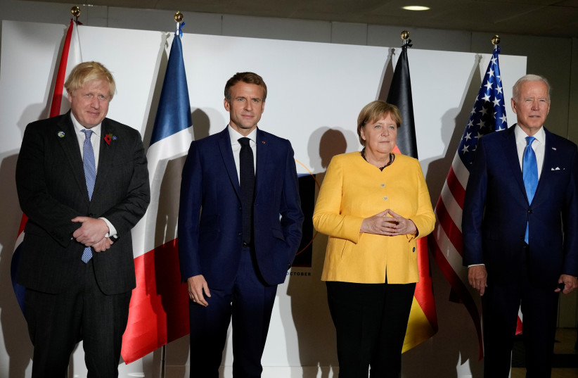  Britain's Prime Minister Boris Johnson, France's President Emmanuel Macron, Germany's Chancellor Angela Merkel and U.S. President Joe Biden pose for a family photo prior to a meeting during the G20 leaders' summit in Rome, Italy October 30, 2021.  (photo credit: KIRSTY WIGGLESWORTH/REUTERS)