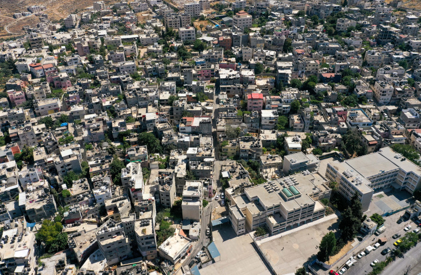  A picture taken with a drone shows Palestinian houses and buildings at Dheisheh refugee camp, near Bethlehem in the West Bank June 17, 2021. Picture taken June 17, 2021.  (photo credit: REUTERS/YOSRI ALJAMAL)