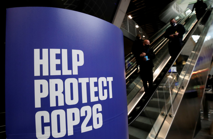A banner advertising the UN Climate Change Conference (COP 26) where world leaders discuss how to tackle climate change on a global scale, is seen inside the conference area in Glasgow Scotland, Britain October 31, 2021. (credit: YVES HERMAN/REUTERS)