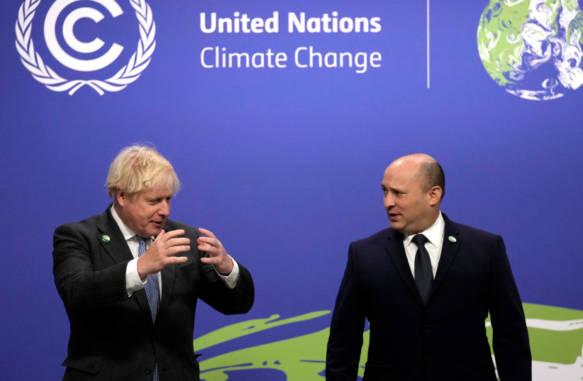  British Prime Minister Boris Johnson greets Israel's Prime Minister Naftali Bennett as he arrives for the UN Climate Change Conference (COP26) in Glasgow, Scotland, Britain November 1, 2021. (credit: ALASTAIR GRANT/POOL VIA REUTERS)