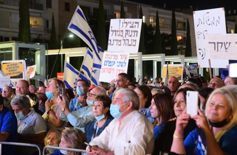  Right wing protestors at a rally on November 2, 2021 at Habima Square in Tel Aviv. The signs read ''Help! An oversized baby is running the country'' and ''Two states for two peoples - Jordan and Israel'' (credit: AVSHALOM SASSONI/MAARIV)