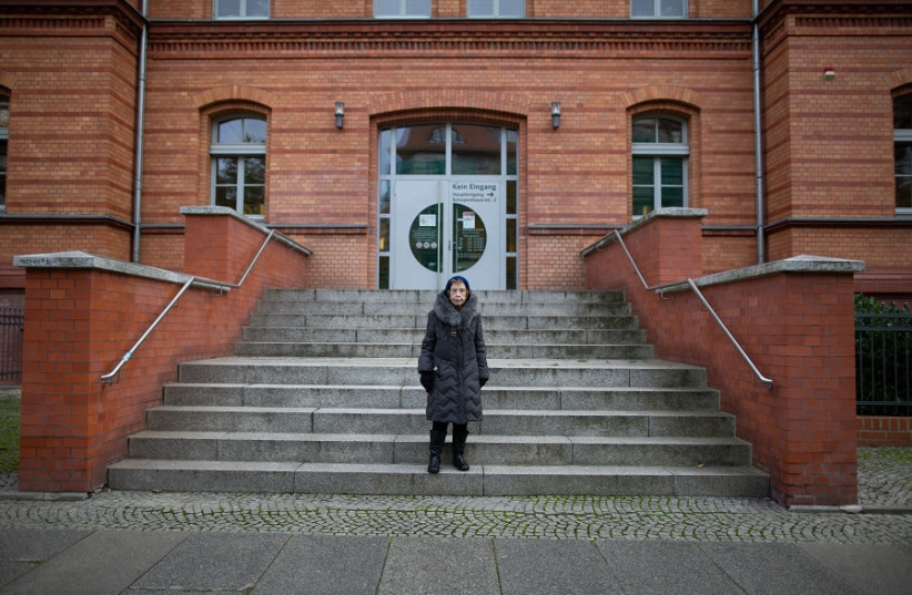  Eve next to the building that served as the police station during the Holocaust (credit: SAM CHURCHILL)