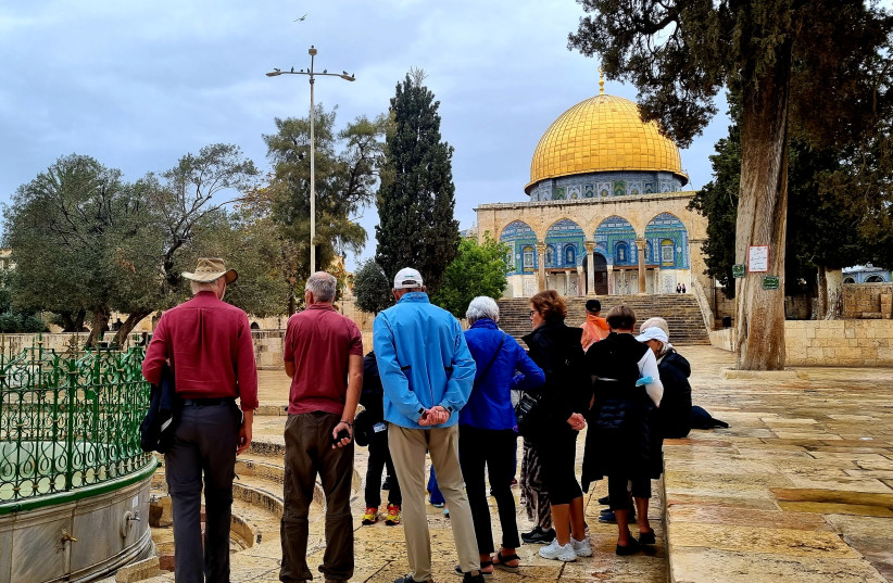  A group Israeli tourists begin their visit to Al-Aqsa/Temple Mount on October 31, 2021; the iconic Dome of the Rock shrine is seen ahead. (credit: MAYA MARGIT/THE MEDIA LINE)