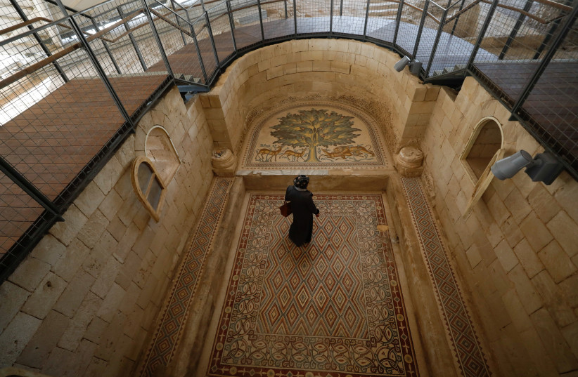 A Palestinian visits Hisham's Palace that has one of the largest mosaic panels in the world after it was opened to the public, in Jericho, in the West Bank October 25, 2021. (credit: MOHAMAD TOROKMAN/REUTERS)