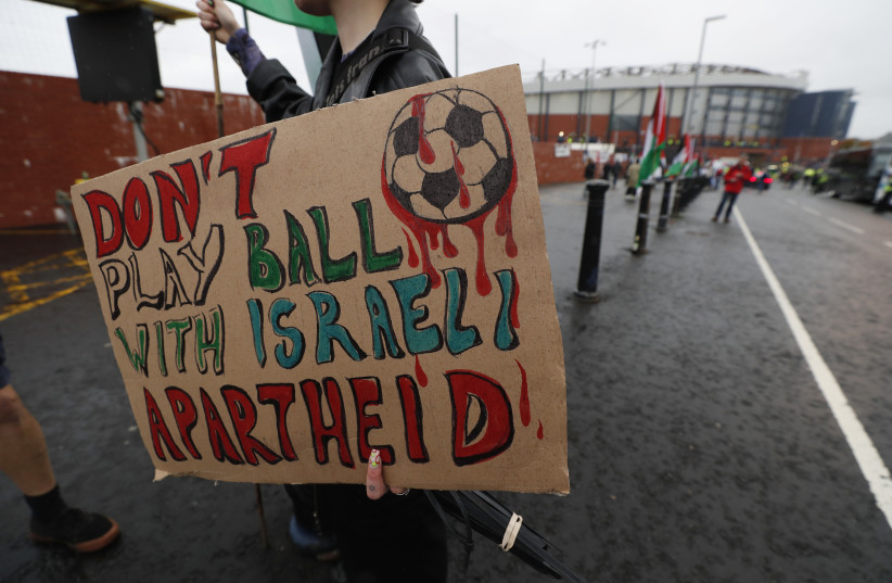  General view as people display signs and Palestine flags outside the stadium before the match (photo credit: ACTION IMAGES/VIA REUTERS)