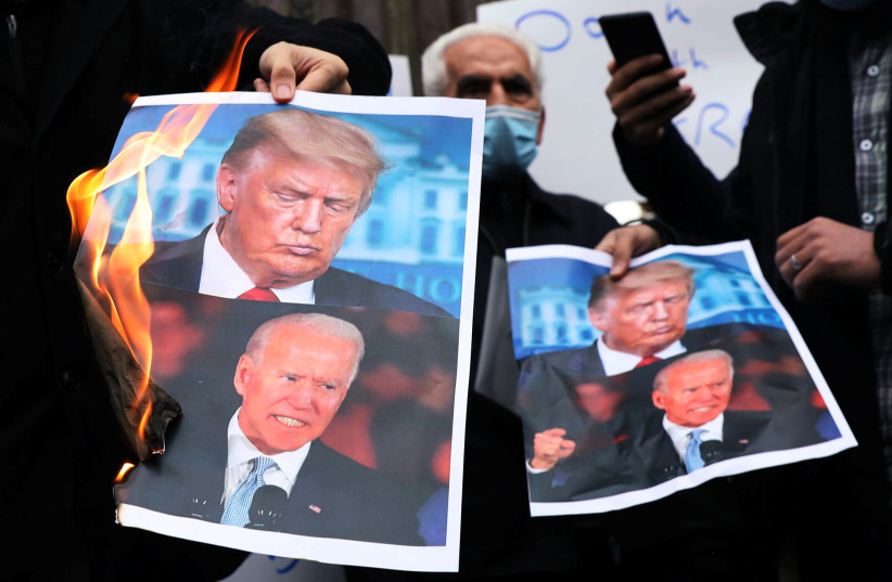  BURNING PICTURES of then-US President-elect Joe Biden and US president Donald Trump during a demonstration  against the killing of Iran’s top nuclear scientist, in Tehran, November 2020. (credit: MAJID ASGARIPOUR/WANA/REUTERS)