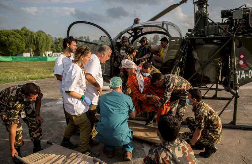  THE IDF evacuates an injured person on a  stretcher for transport via helicopter to a  hospital, in Kathmandu, Nepal, 2015. (photo credit: Illustrative; Danish Siddiqui/Reuters)