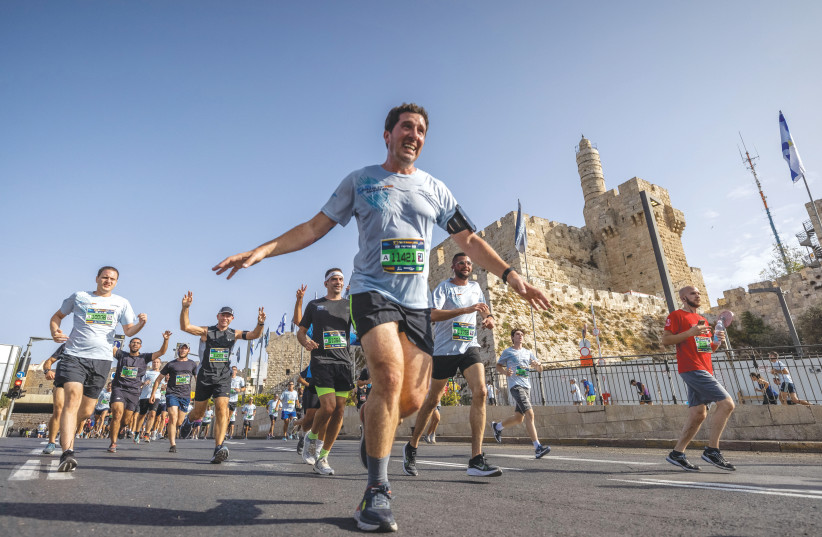  WINNERS: PASSING the Tower of David  during last Friday’s Jerusalem Marathon.  (photo credit: YONATAN SINDEL/FLASH90)