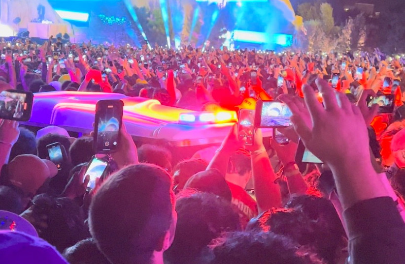  An ambulance is seen in the crowd during the Astroworld music festiwal in Houston, Texas, U.S., November 5, 2021 in this still image obtained from a social media video on November 6, 2021. (photo credit: COURTESY OF TWITTER @ONACASELLA /VIA REUTERS)