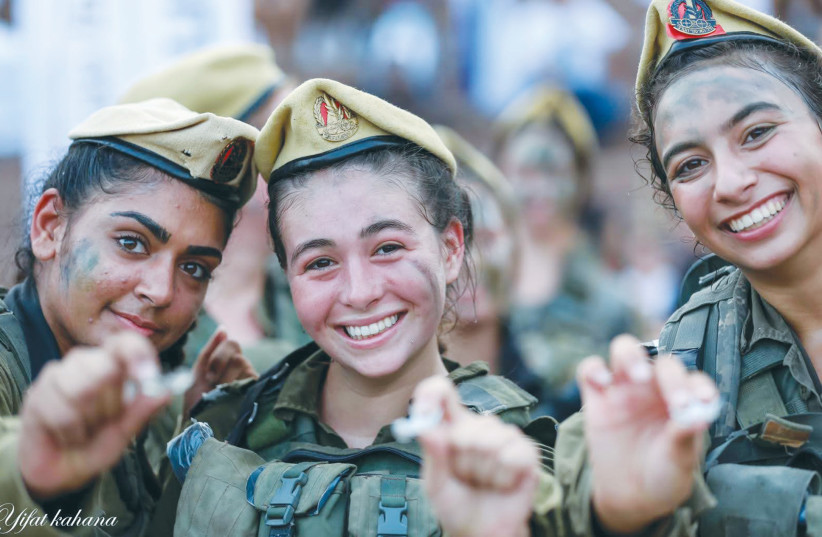  THE WRITER (center) and a couple of her comrades display the badges they received following the final march making them an operational unit. (photo credit: Yifat Kahana/IDF)