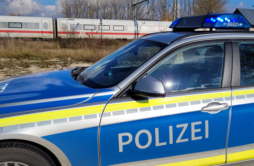 A police car is pictured beside an ICE (Intercity-Express) train in Seubersdorf, Germany, November 6, 2021, after several people were injured in a knife attack in the ICE train between the south German cities of Regensburg and Nuremberg. (credit: REUTERS/AYHAN UYANIK)