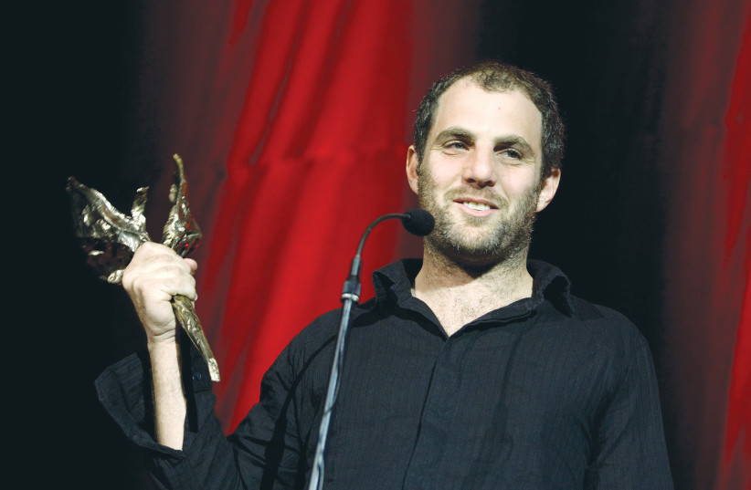  ERAN KOLIRIN holds his Golden Swan award after winning a special prize for ‘The Band’s Visit’ at the Copenhagen Film Festival in 2007. (photo credit: Jens Nørgaard Larsen/SCANPIX via Reuters)