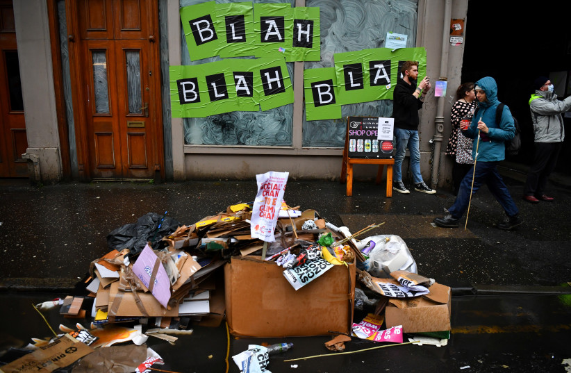  Rubbish is seen on the street during a protest, as the UN Climate Change Conference (COP26) takes place, in Glasgow, Scotland, Britain, November 6, 2021.  (photo credit: REUTERS/DYLAN MARTINEZ)