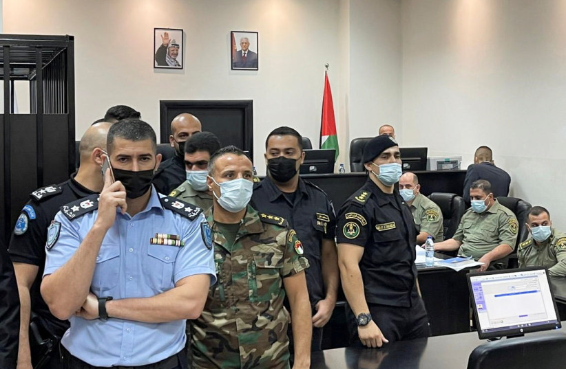  Palestinian security officers stand guard during a trial of security officers (not seen) over the death of Nizar Banat, a critic of President Mahmoud Abbas, in Ramallah in the Israeli-occupied West Bank September 14, 2021 (credit: REUTERS/ALI SAWAFTA)