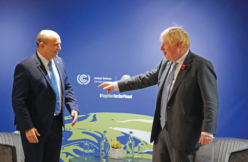  BRITISH PRIME MINISTER Boris Johnson greets his Israeli counterpart, Naftali Bennett, at the UN Climate Change Conference in Glasgow last week. (photo credit: Alberto Pezzali/Reuters)