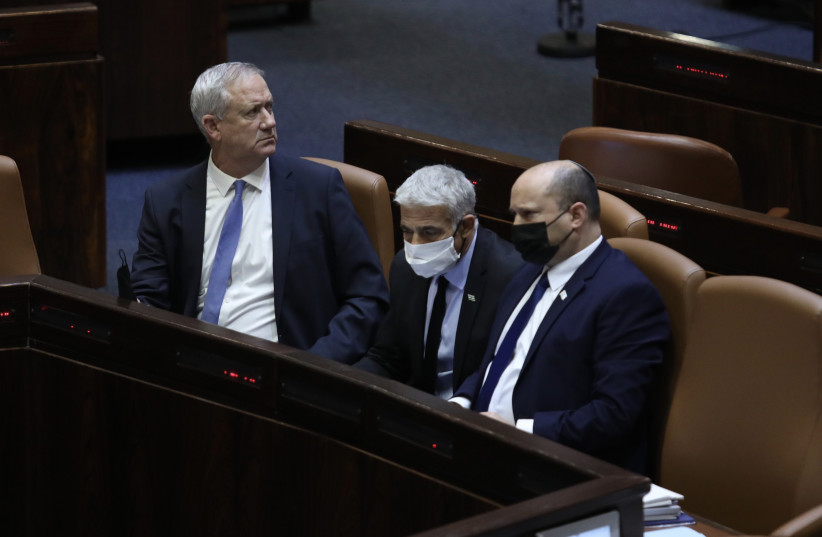  DEFENSE MINISTER Benny Gantz, Foreign Minister Yair Lapid, Prime Minister Naftali Bennett and Justice Minister Gideon Sa’ar at the opening of the winter session at the Knesset, November 8, 2021. (photo credit: MARC ISRAEL SELLEM/THE JERUSALEM POST)
