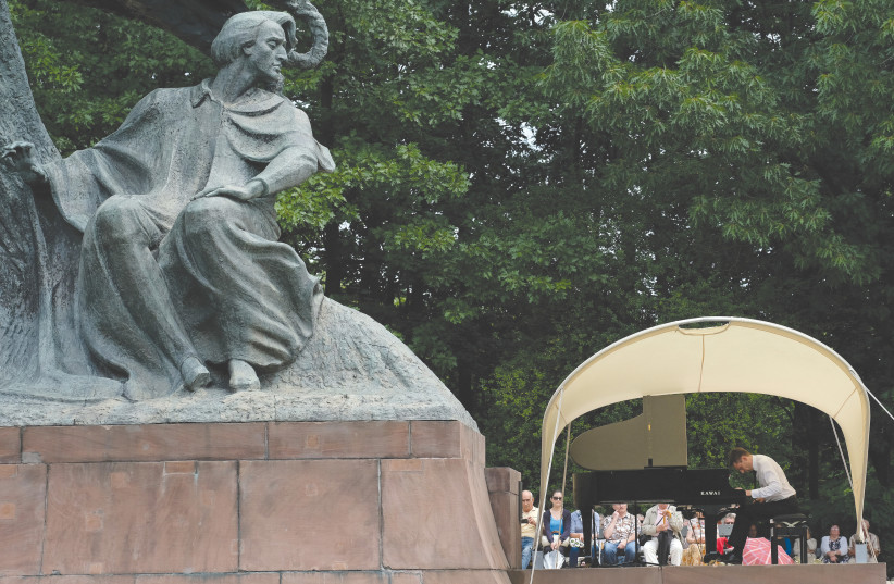  A PIANIST performs a composition by Frédéric Chopin next to a statue of Chopin during a concert in Lazienki Park in Warsaw in July 2017. (credit: RICKEY ROGERS/REUTERS)