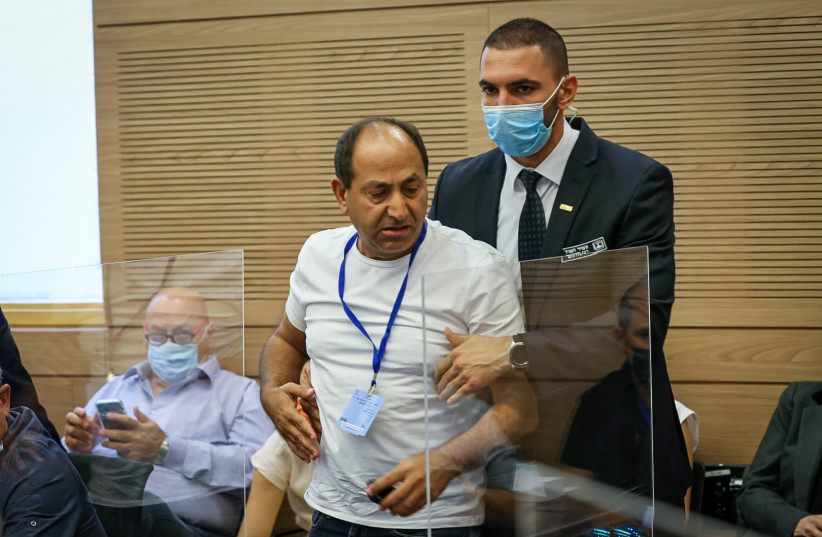 Israeli supermarket chain owner and businessman Rami Levy is seen being thrown out of a Knesset Economics Committee debate after insulting MKs, on November 10, 2021. (photo credit: NOAM MOSCOWITZ/KNESSET SPOKESMAN'S OFFICE)