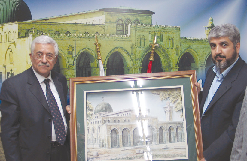 Palestinian Authority President Mahmoud Abbas (left) receives a poster of al-Aqsa Mosque from then-Hamas leader Khaled Mashaal during a meeting in Damascus in 2005. (photo credit: REUTERS/HANDOUT JS/KI)