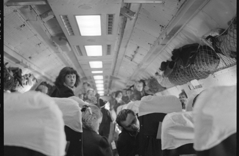  REFUGEES FROM the failed Hungarian Revolution on a plane en route to the US, 1957. (credit: PICRYL)