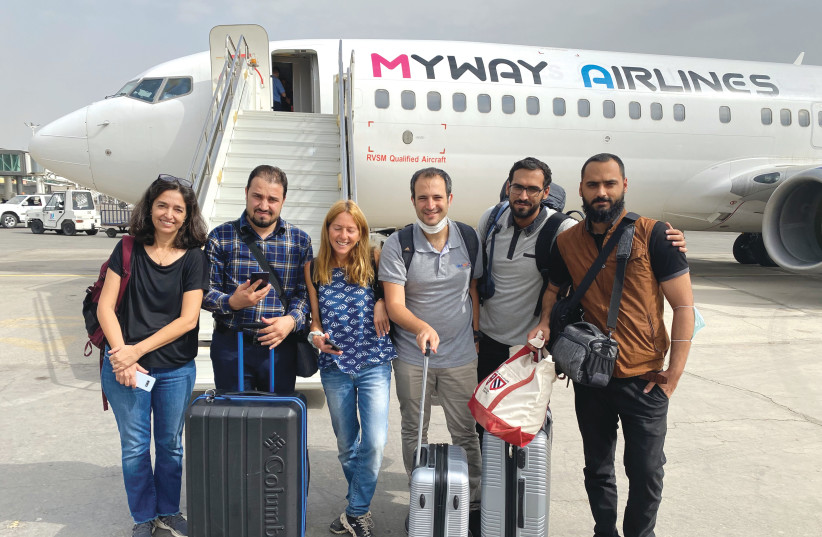 The Israeli IsraAid team, Yotam Polizer, Danna Harman and Roni Aboulafia, getting on the evacuation flight together with the Afghan delegation leaders. (photo credit: ISRAID)