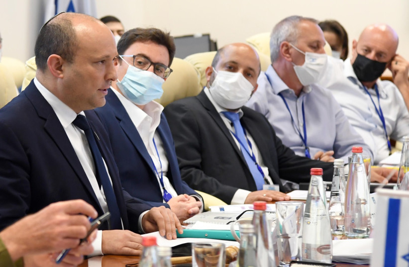 Israel's Prime Minister Naftali Bennett and other top officials are seen following the completion of the COVID-19 'war games' exercise. (photo credit: HAIM ZACH/GPO)