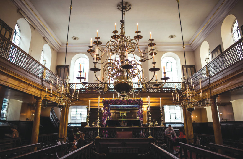  LONDON’S BEVIS Marks Synagogue, founded in 1701 by crypto-Jews who had fled from Spain and Portugal via the Netherlands, is considered British Jewry’s cathedral house of prayer with the pomp of circumstance. The synagogue is illuminated by 240 candles placed in its enormous brass chandeliers.  (credit: BEVIS MARKS SYNAGOGUE HERITAGE FOUNDATION)