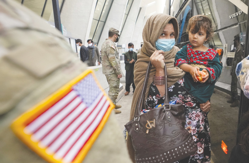  AFGHAN REFUGEES arrive at Dulles International Airport in Virginia in September. (photo credit: KEVIN LAMARQUE/REUTERS)