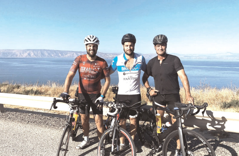  RUVI ARINOS (right) and his sons, Or and Din, pose overlooking the Kinneret during their training for the IRONMAN 70.3 Tiberias, which took place on Friday.  (photo credit: Courtesy)