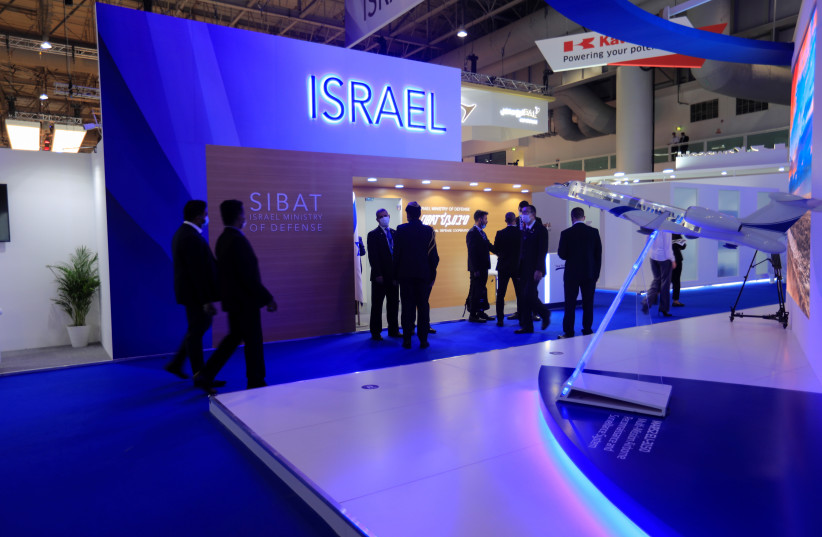  People walk past the Israeli display during the Dubai Air Show in Dubai, United Arab Emirates, November 14, 2021. (credit:  REUTERS/STAFF)