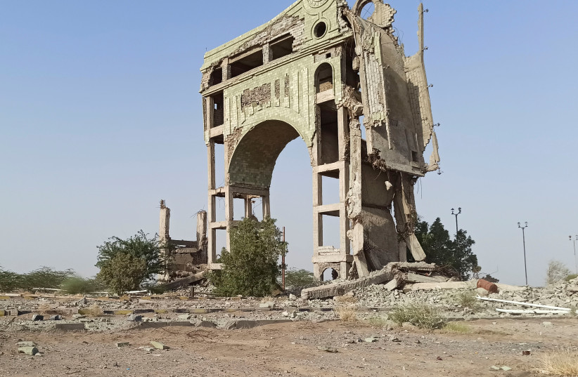  A view of an arch damaged by clashes is seen on the outskirts of the Red Sea port city of Hodeidah, Yemen November 13, 2021. Picture taken November 13, 2021. (photo credit: REUTERS/MANAL QAED)
