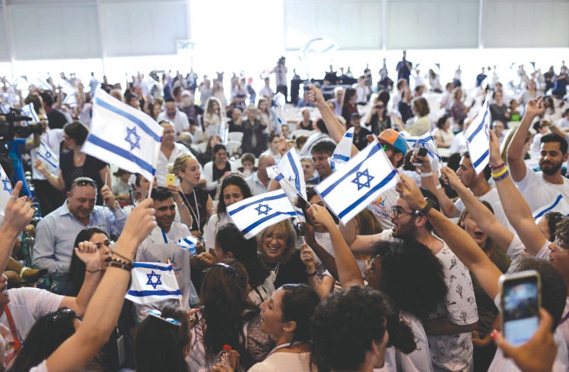Friends and family welcome new immigrants at Ben-Gurion Airport. (photo credit: TOMER NEUBERG/FLASH90)