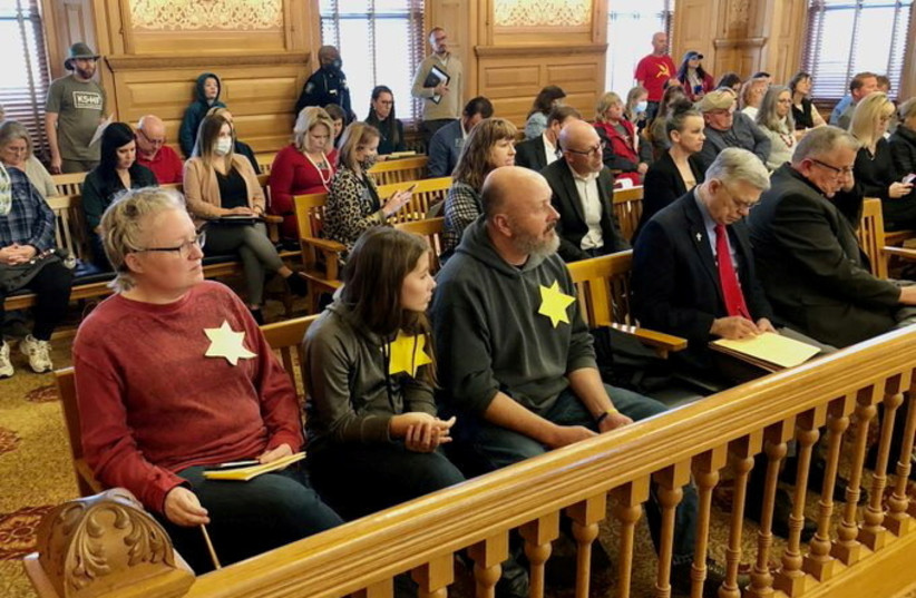  Daran Duffy and family wear stars in the style of the Star of David during an appearance before the Special Committee on Government Overreach and the Impact of COVID-19 Mandates in Topeka. (photo credit: Thad Allton - Kansas Reflector/via REUTERS)