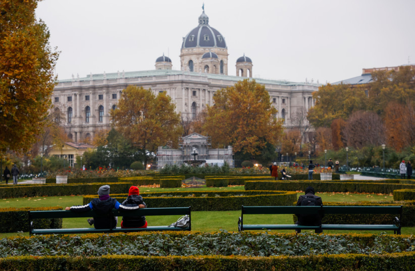  People sit in a public garden amidst the coronavirus disease (COVID-19) outbreak, as Austria's government imposes a lockdown on people who are not fully vaccinated, in Vienna, Austria November 14, 2021. (photo credit: LEONHARD FOEGER / REUTERS)