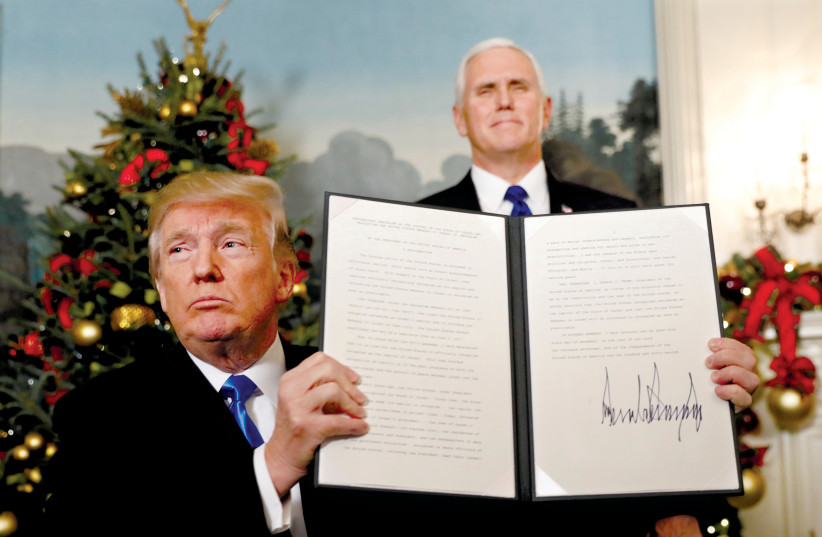  THEN-US PRESIDENT Donald Trump holds up the proclamation he signed that the United States recognizes Jerusalem as the capital of Israel. (credit: KEVIN LAMARQUE/REUTERS)