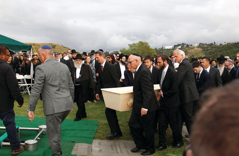  LORI GILBERT-KAYE, killed in a shooting at a Chabad synagogue, is laid to rest at an San Diego cemetery in 2019. (photo credit: JOHN GASTALDO/REUTERS)