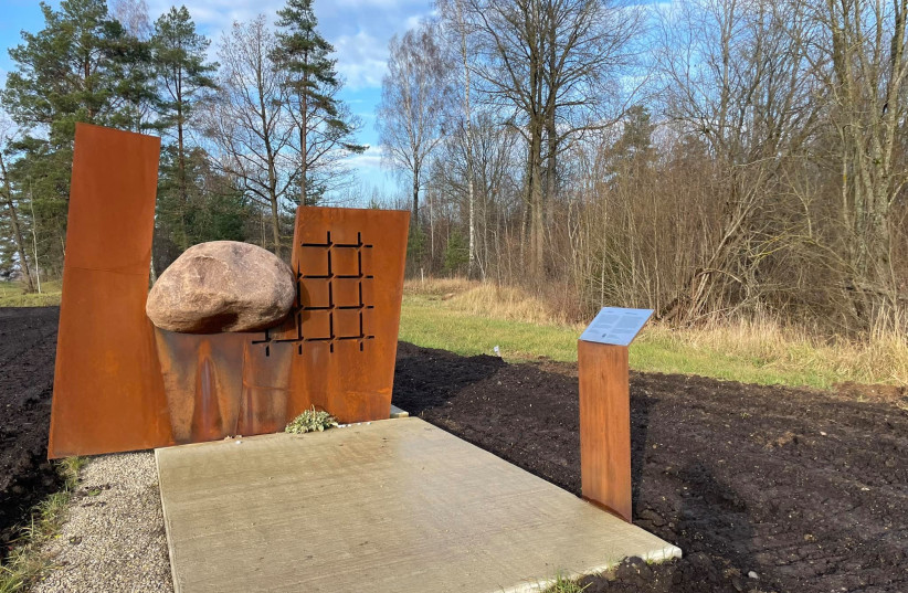  A bicycle path passes on either side of a monument to Holocaust survivors buried in a mass grave in Šiauliai, Lithuania, pictured on Nov. 10, 2021. (photo credit: Courtesy of Rabbi Kalev Kerlin/JTA)
